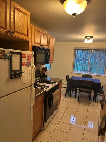 a kitchen with stainless steel appliances granite countertop a stove a sink dishwasher and a microwave