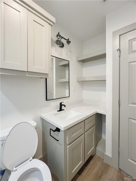 604 North 11th Street McAllen, TX 78501 - Photo 17 of 20 a bathroom with a toilet sink and mirror