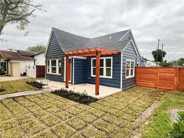 a view of a house with wooden fence