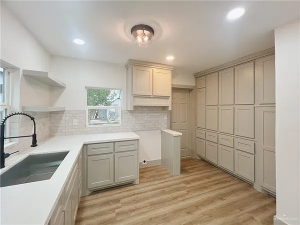 a kitchen with a sink cabinets and window
