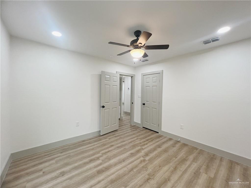 604 North 11th Street McAllen, TX 78501 - Photo 10 of 20 a view of room with wooden floor and ceiling fan