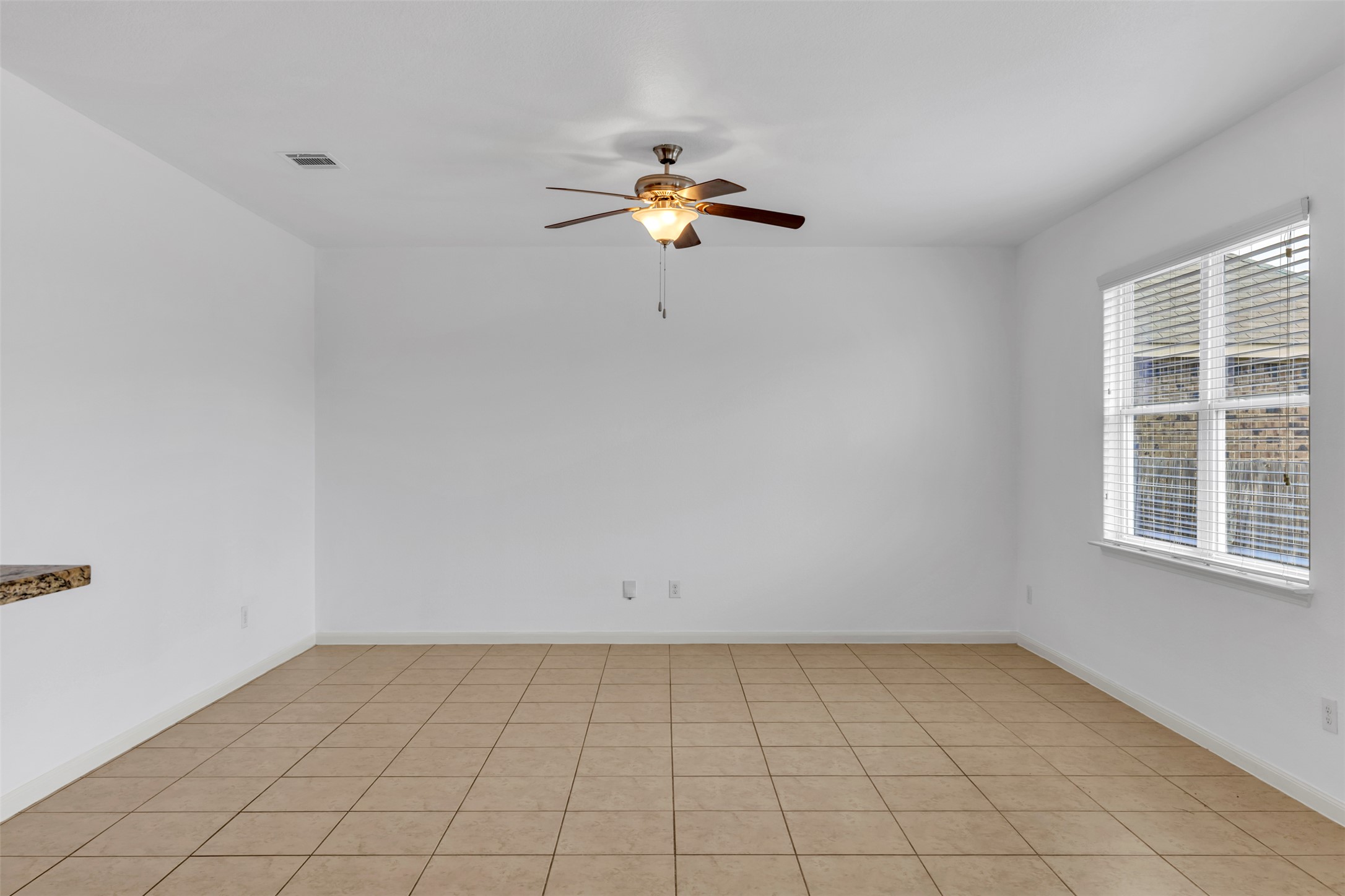 13213 Clara Martin Road Manor, TX 78653 - Photo 14 of 38 Unfurnished room featuring a ceiling fan and light tile patterned flooring