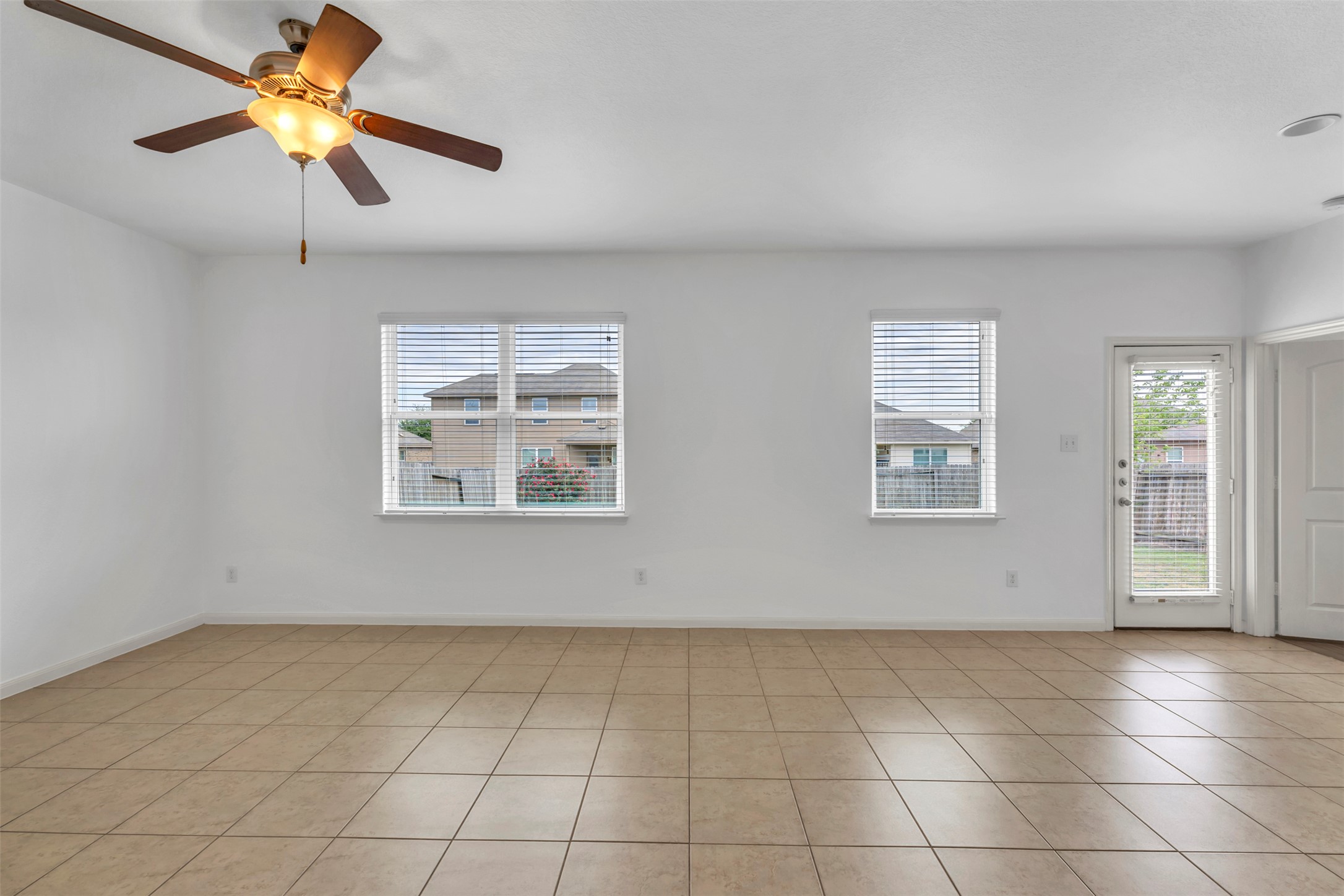 13213 Clara Martin Road Manor, TX 78653 - Photo 19 of 38 Empty room featuring a ceiling fan and light tile patterned floors