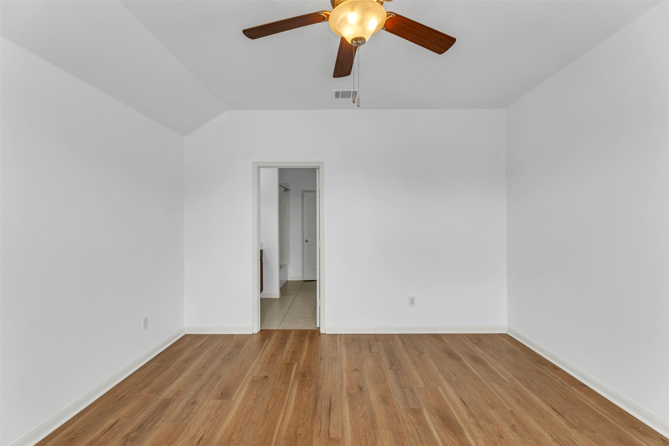 13213 Clara Martin Road Manor, TX 78653 - Photo 22 of 38 Spare room with light wood-style floors, ceiling fan, and vaulted ceiling