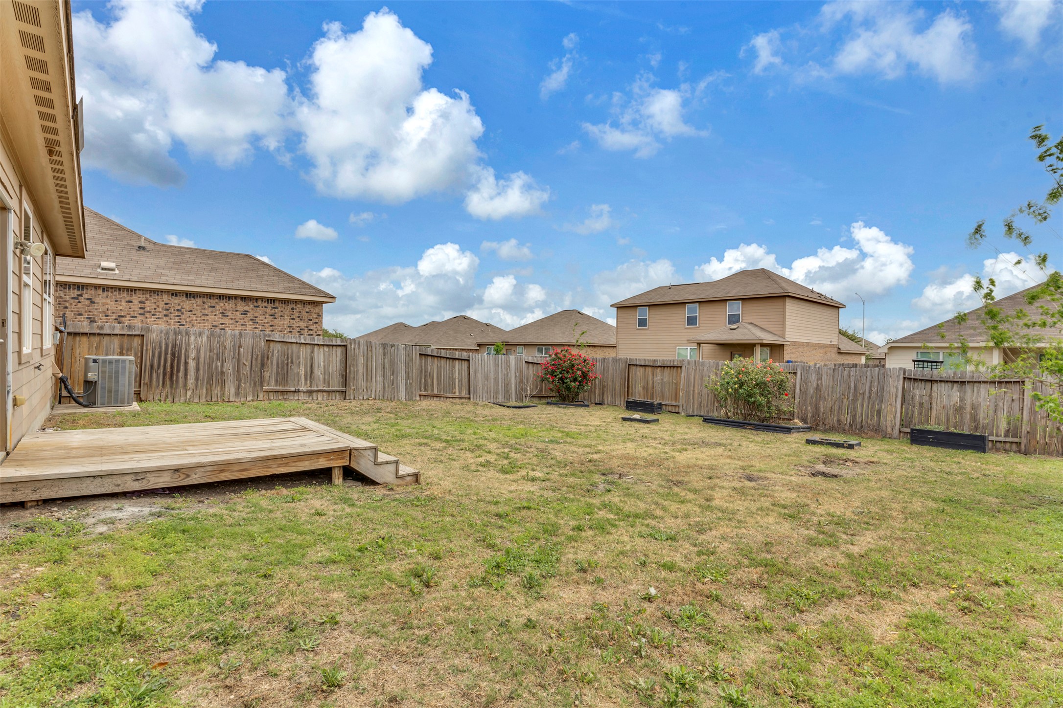 13213 Clara Martin Road Manor, TX 78653 - Photo 29 of 38 Fenced backyard featuring a wooden deck and a residential view