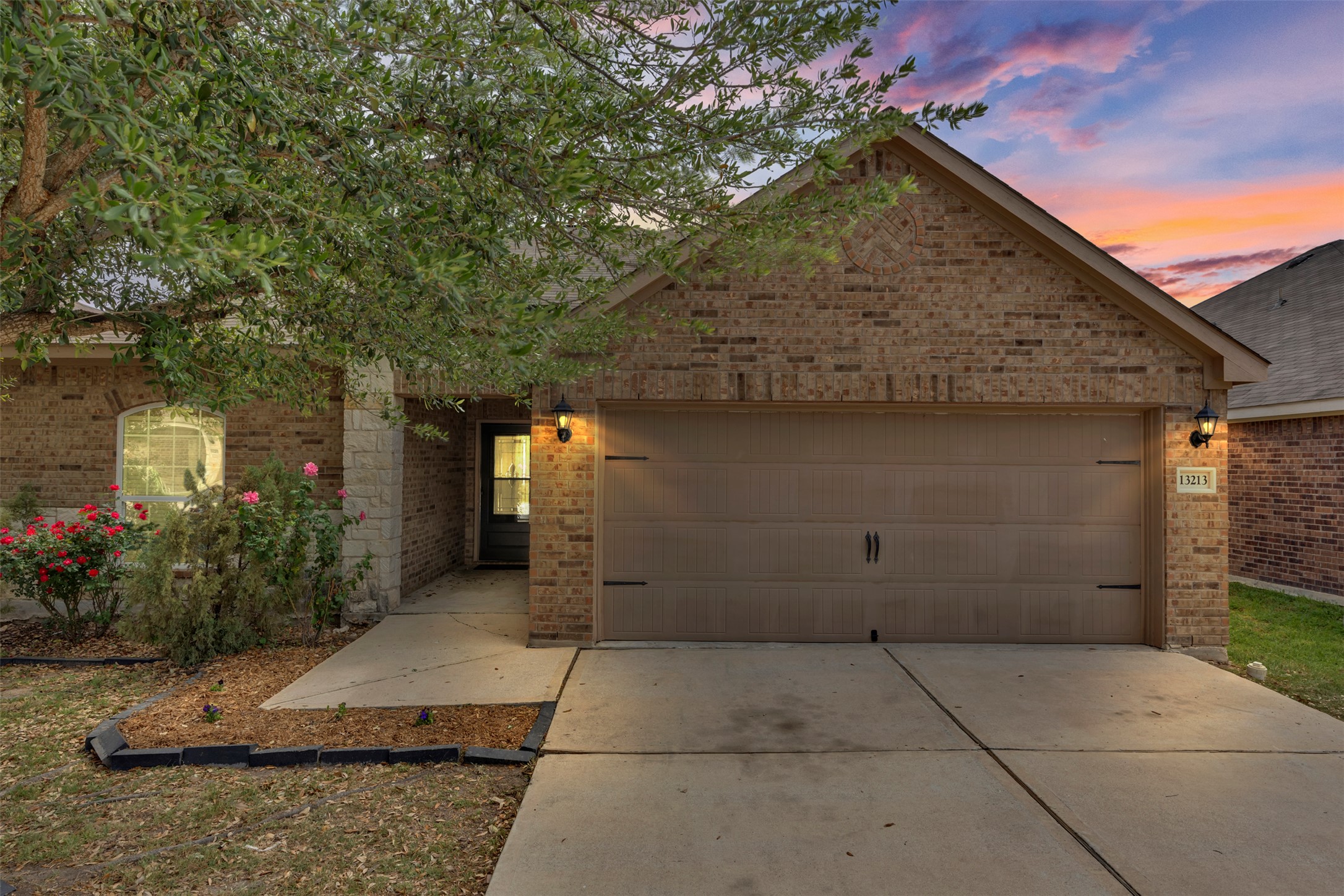 13213 Clara Martin Road Manor, TX 78653 - Photo 3 of 38 View of front of house featuring brick siding, a garage, and concrete driveway