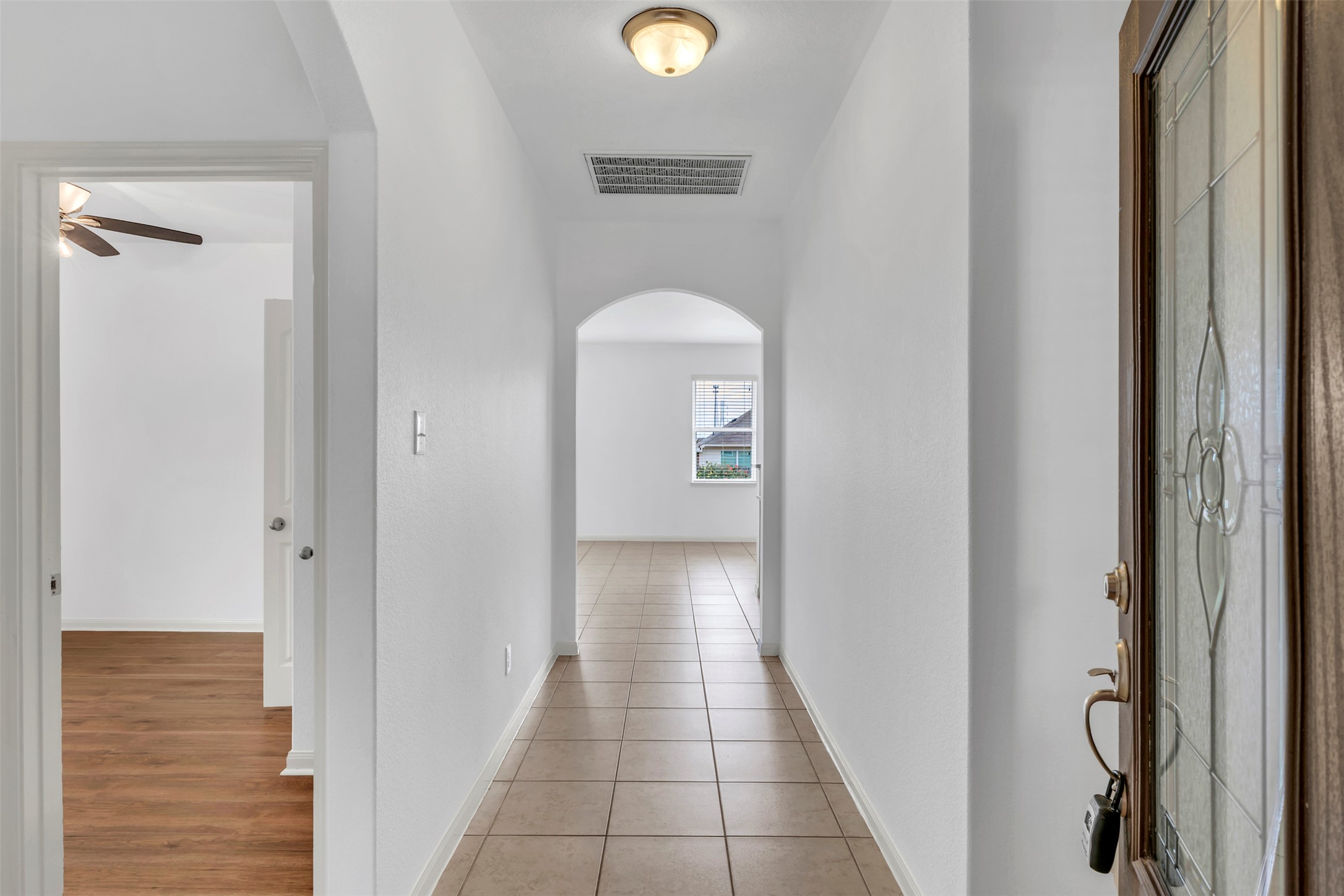13213 Clara Martin Road Manor, TX 78653 - Photo 6 of 38 Hall with arched walkways and light tile patterned floors