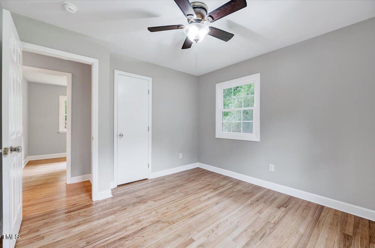 592 Perdues Road Louisburg, NC 27549 - Photo 12 of 27 a view of empty room with wooden floor and fan