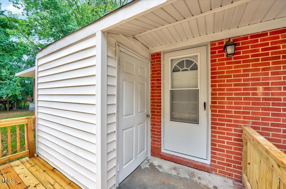 592 Perdues Road Louisburg, NC 27549 - Photo 18 of 27 a view of a house with a door and wooden walls