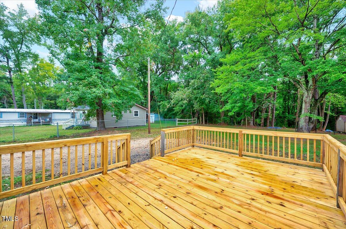 592 Perdues Road Louisburg, NC 27549 - Photo 20 of 27 a view of balcony with wooden floor and fence