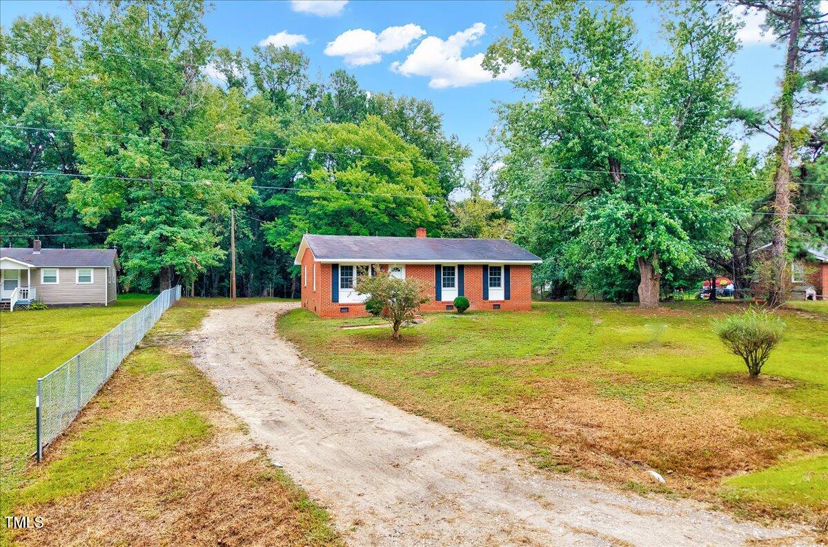 592 Perdues Road Louisburg, NC 27549 - Photo 22 of 27 a view of a house with a yard patio and a tree