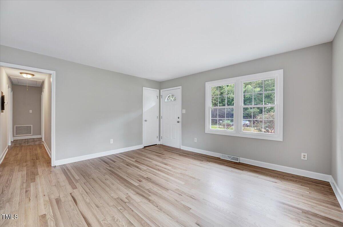 592 Perdues Road Louisburg, NC 27549 - Photo 8 of 27 a view of an empty room with wooden floor and a window