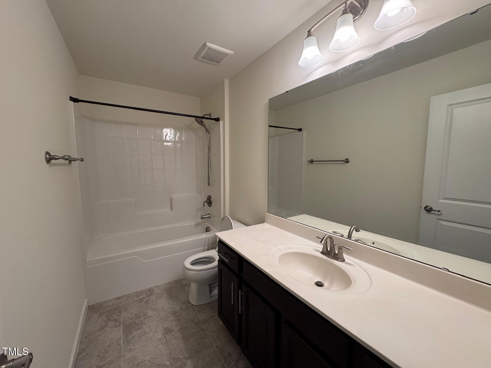 1205 Elliott Ridge Lane Morrisville, NC 27560 - Photo 12 of 32 a bathroom with a double vanity sink toilet mirror and bathtub