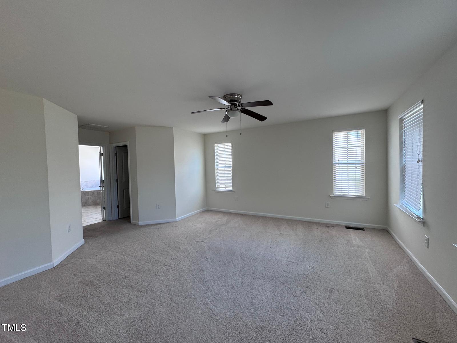 1205 Elliott Ridge Lane Morrisville, NC 27560 - Photo 18 of 32 a view of a livingroom with a ceiling fan and window