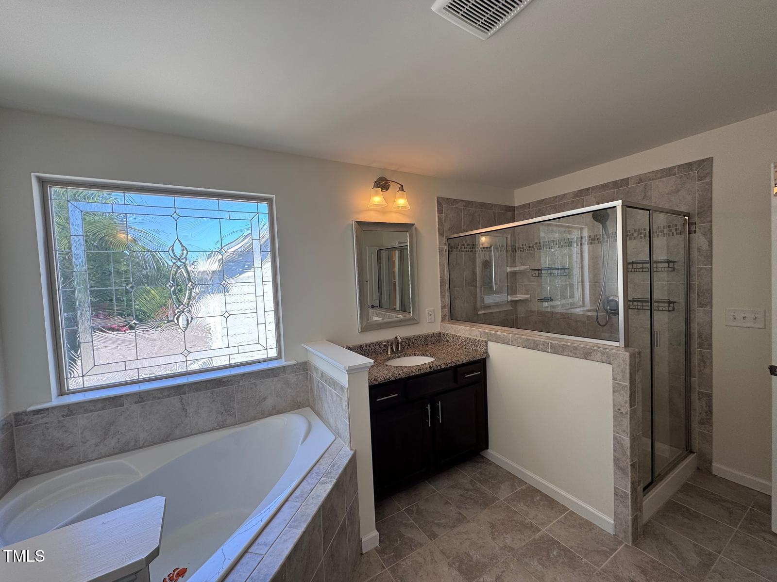 1205 Elliott Ridge Lane Morrisville, NC 27560 - Photo 19 of 32 a bath room with a bath tub and shower