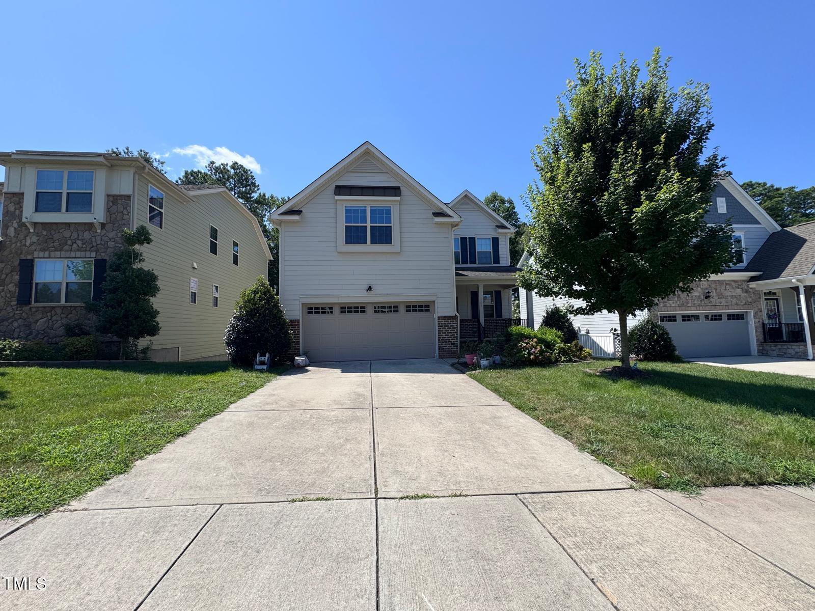 1205 Elliott Ridge Lane Morrisville, NC 27560 - Photo 2 of 32 a front view of a house with a garden