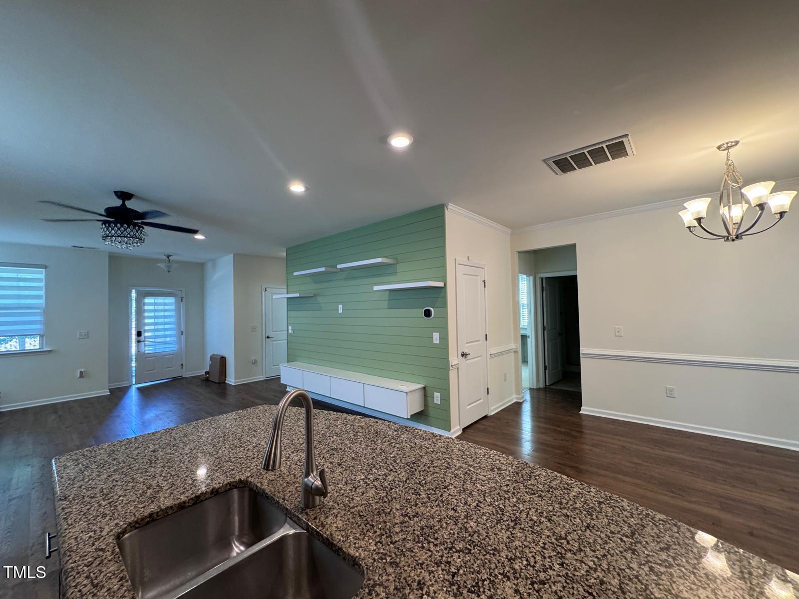 1205 Elliott Ridge Lane Morrisville, NC 27560 - Photo 21 of 32 a view of a room with wooden floor and staircase
