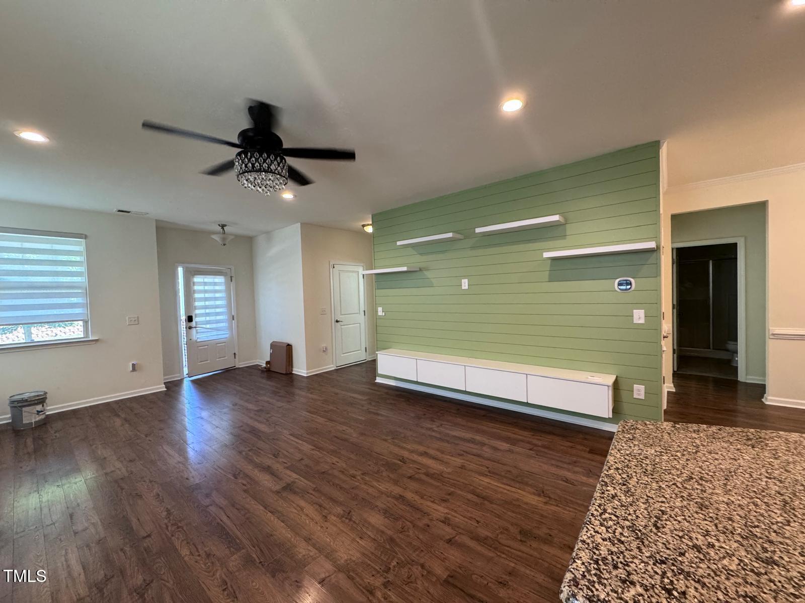 1205 Elliott Ridge Lane Morrisville, NC 27560 - Photo 26 of 32 a view of a livingroom with wooden floor and a ceiling fan
