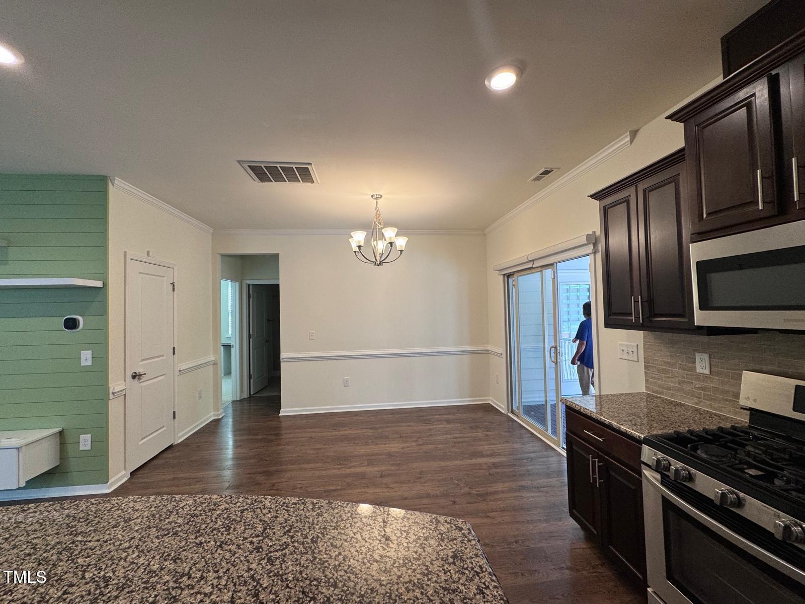 1205 Elliott Ridge Lane Morrisville, NC 27560 - Photo 4 of 32 a kitchen with stainless steel appliances granite countertop a stove a sink and a refrigerator