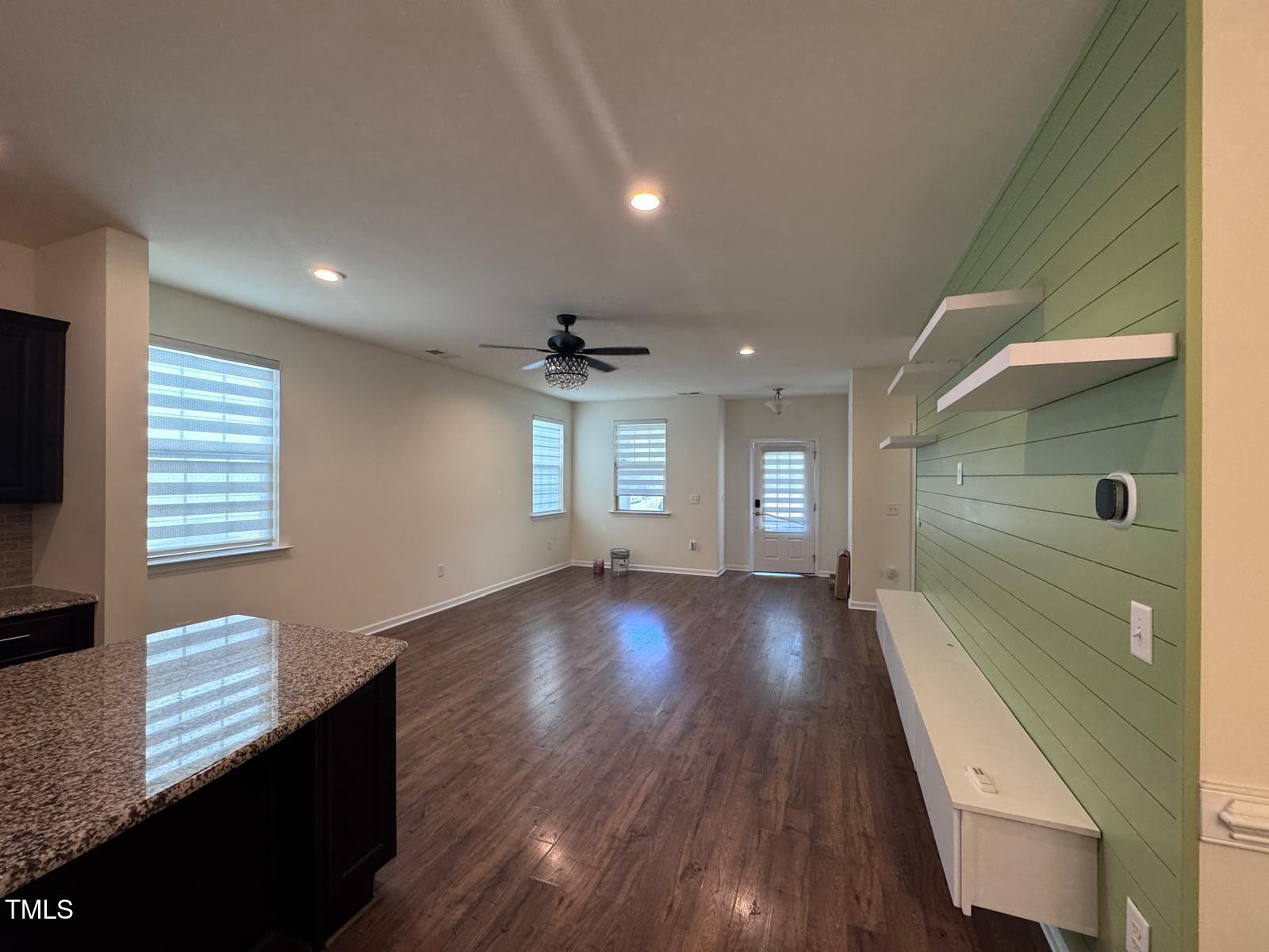 1205 Elliott Ridge Lane Morrisville, NC 27560 - Photo 7 of 32 a view of an empty room with wooden floor and a window