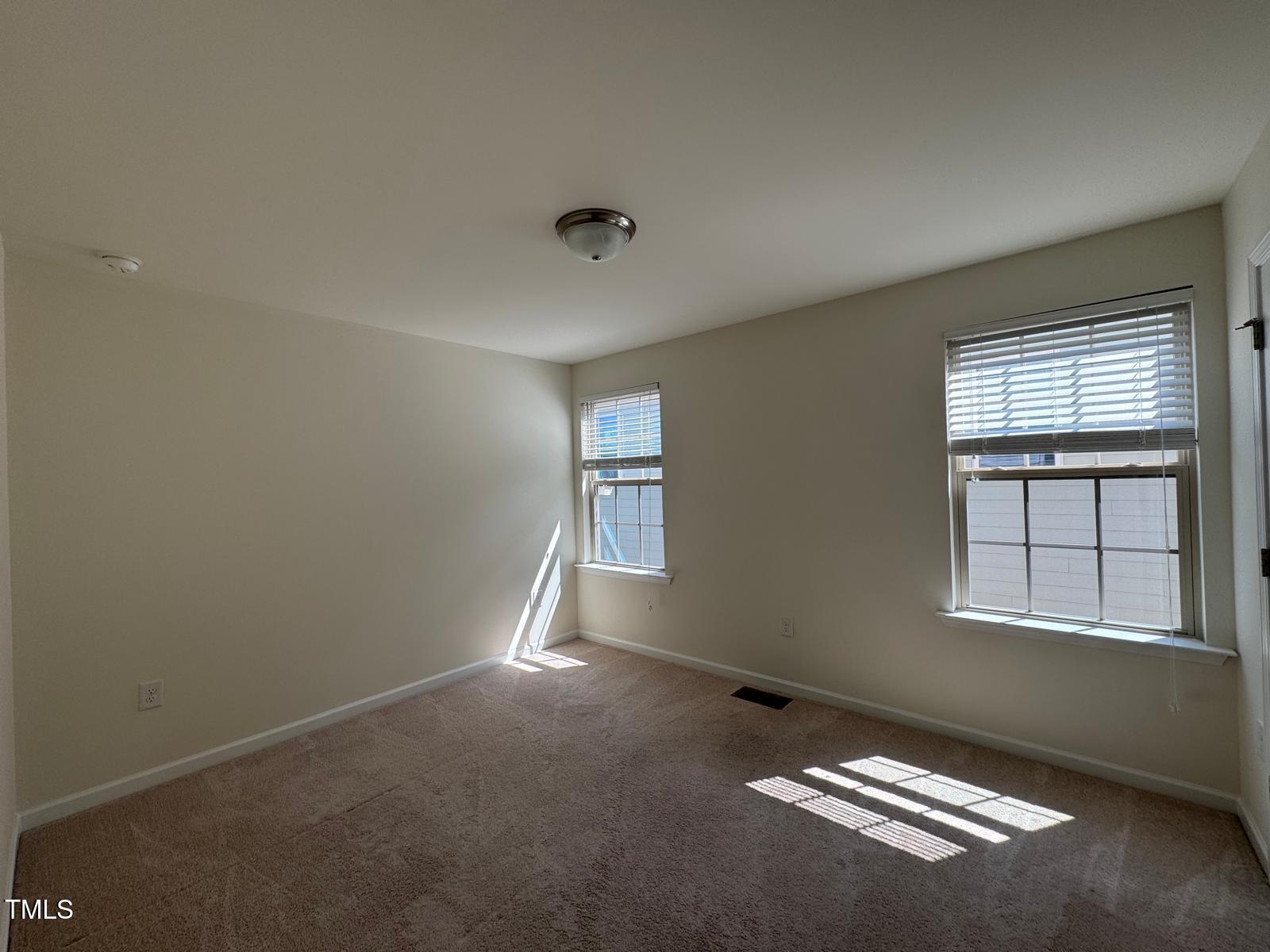 1205 Elliott Ridge Lane Morrisville, NC 27560 - Photo 10 of 32 an empty room with windows