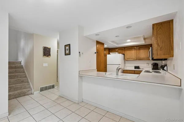 a kitchen with stainless steel appliances a refrigerator and a stove top oven