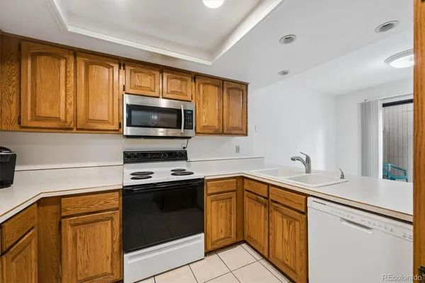 a kitchen with a sink stove top oven and cabinets