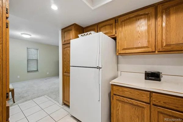 a kitchen with a refrigerator and cabinets