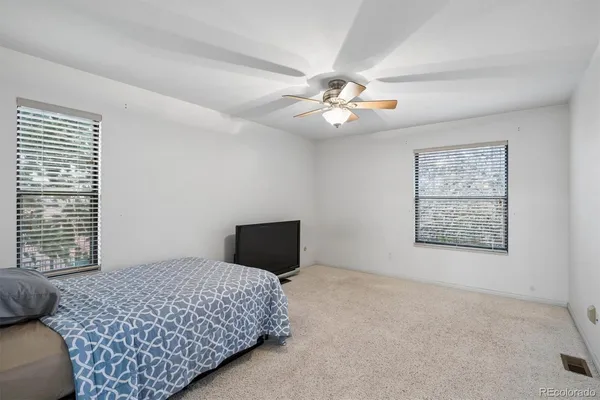 a bedroom with a large bed and a window