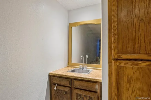 a bathroom with a granite countertop sink and a mirror