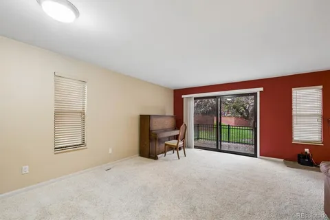 a view of a livingroom with a large window and chair