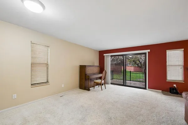 a view of a livingroom with a large window and chair
