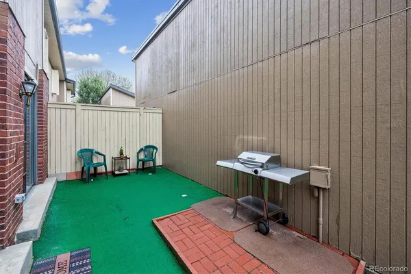 a view of a chair and table in backyard