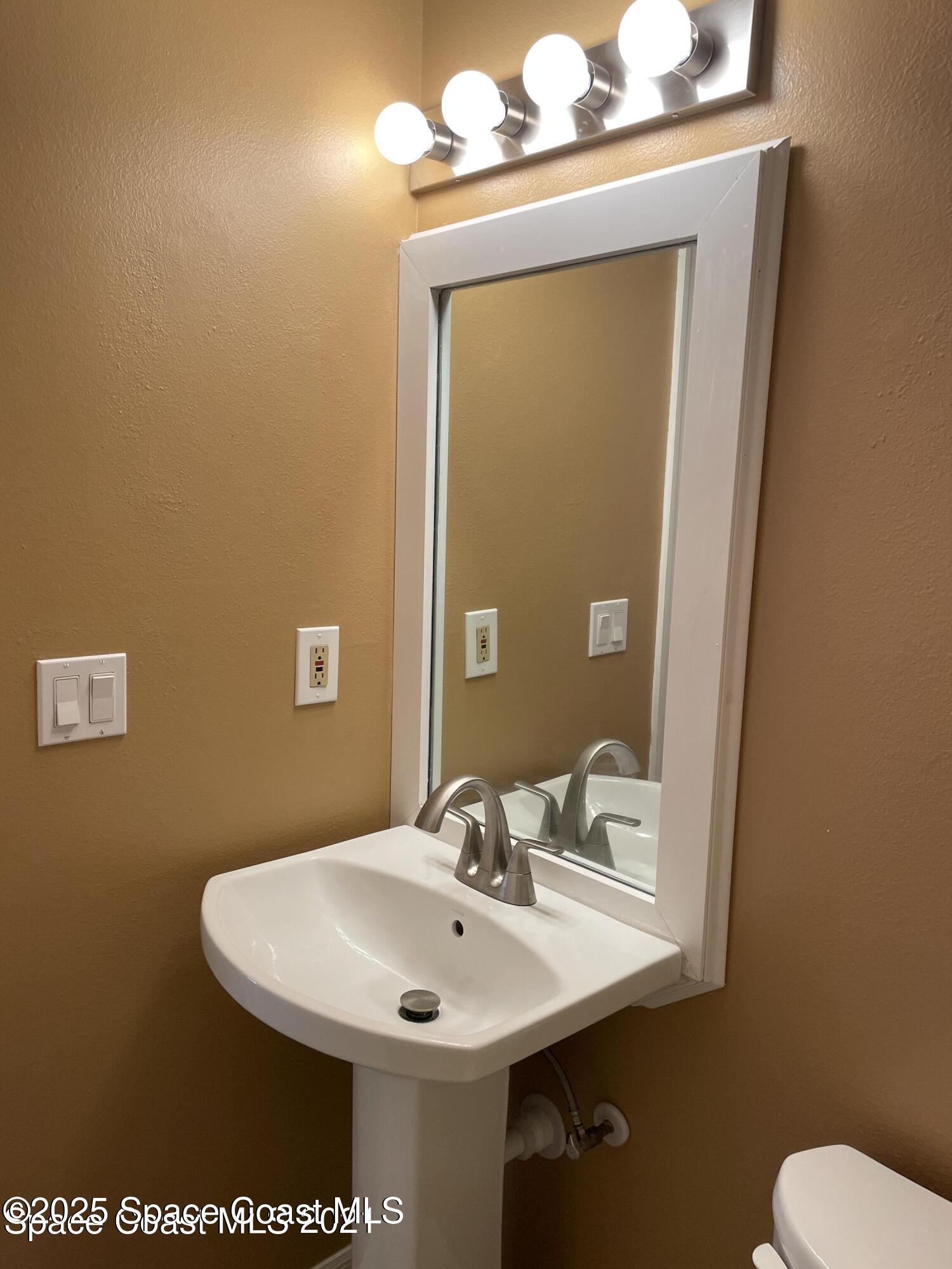 1720 Murrell Road, Unit 217 Rockledge, FL 32955 - Photo 21 of 24 a bathroom with a sink and a mirror