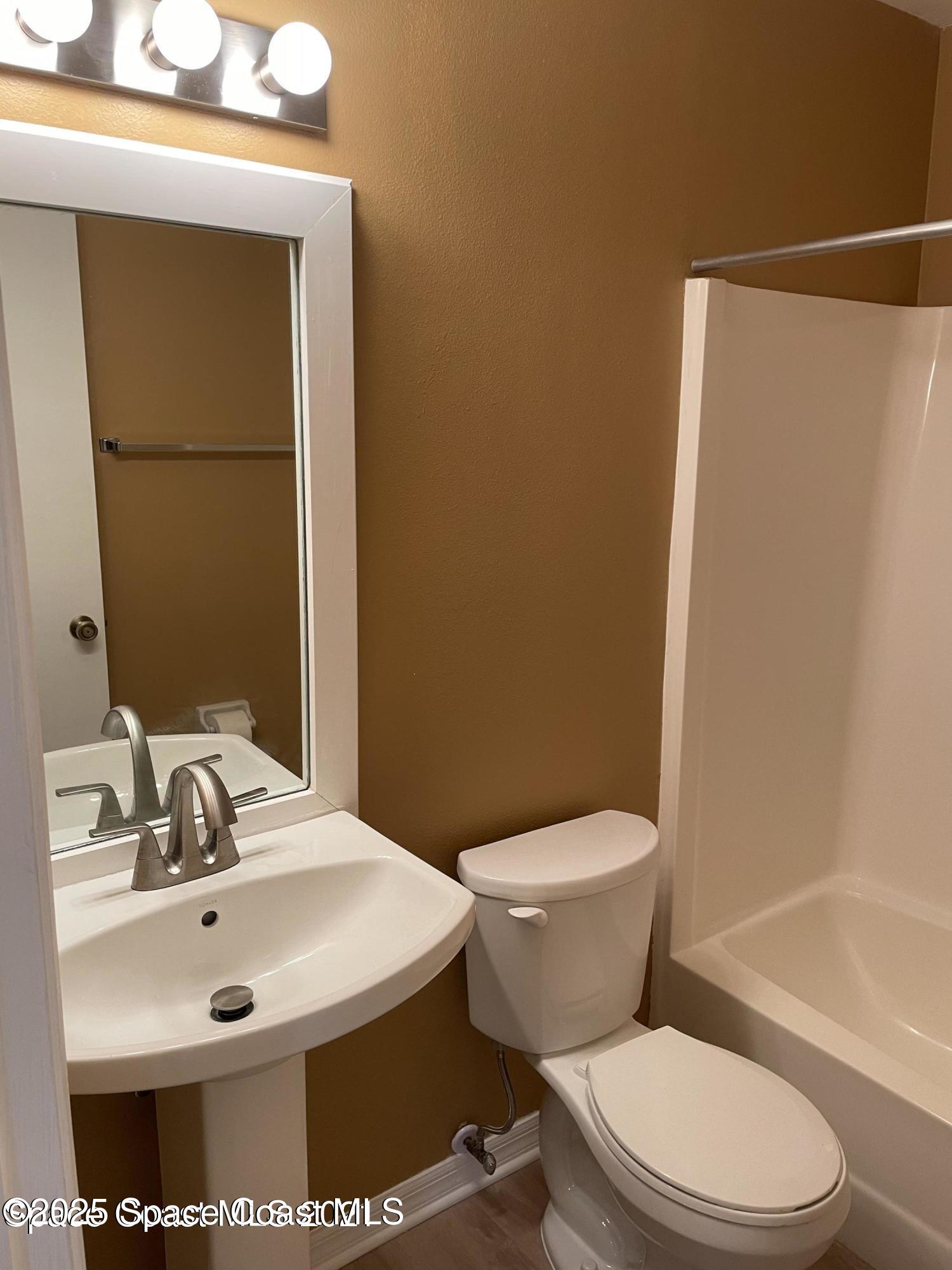 1720 Murrell Road, Unit 217 Rockledge, FL 32955 - Photo 22 of 24 a bathroom with a sink toilet and shower