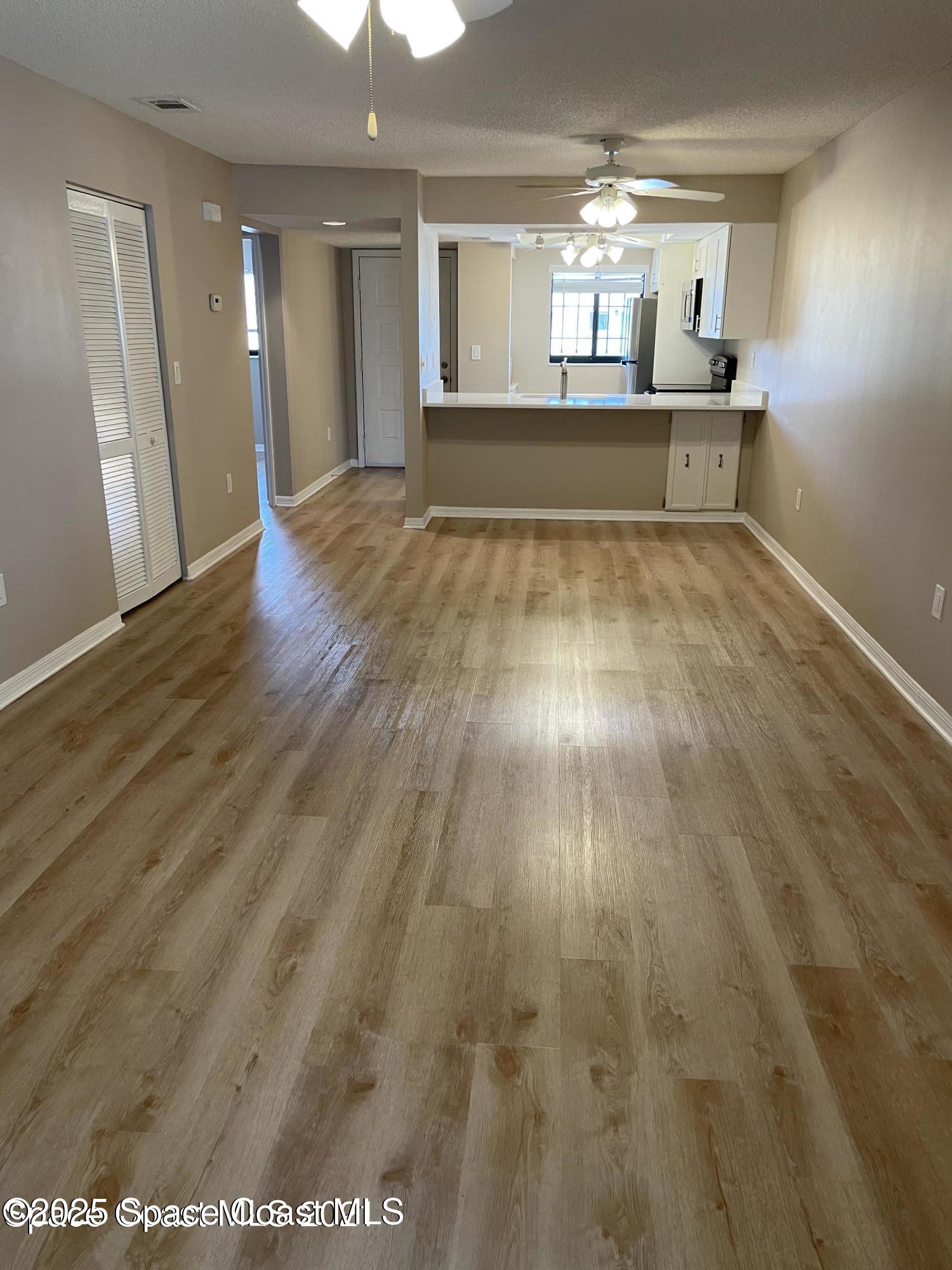 1720 Murrell Road, Unit 217 Rockledge, FL 32955 - Photo 3 of 24 a view of empty room with wooden floor
