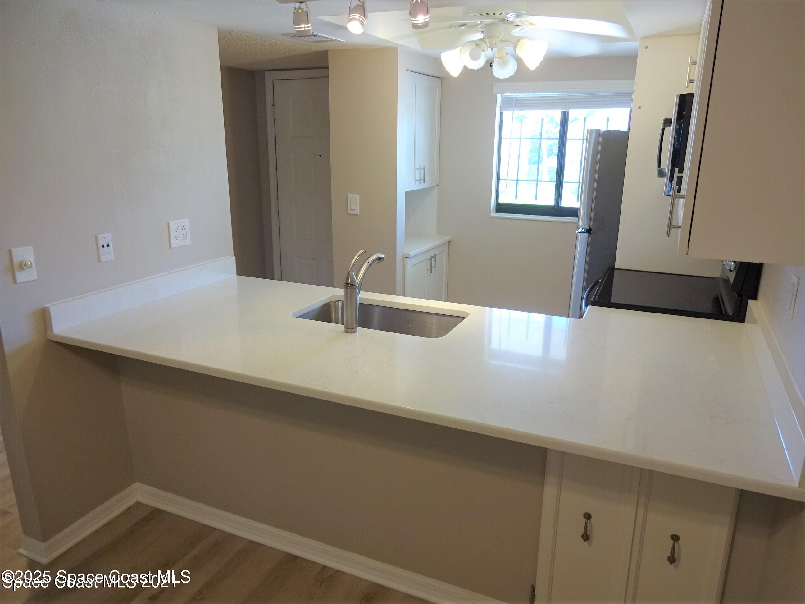 1720 Murrell Road, Unit 217 Rockledge, FL 32955 - Photo 5 of 24 a bathroom with a sink a vanity and a mirror