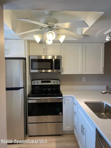 a kitchen with a sink stainless steel appliances and cabinets