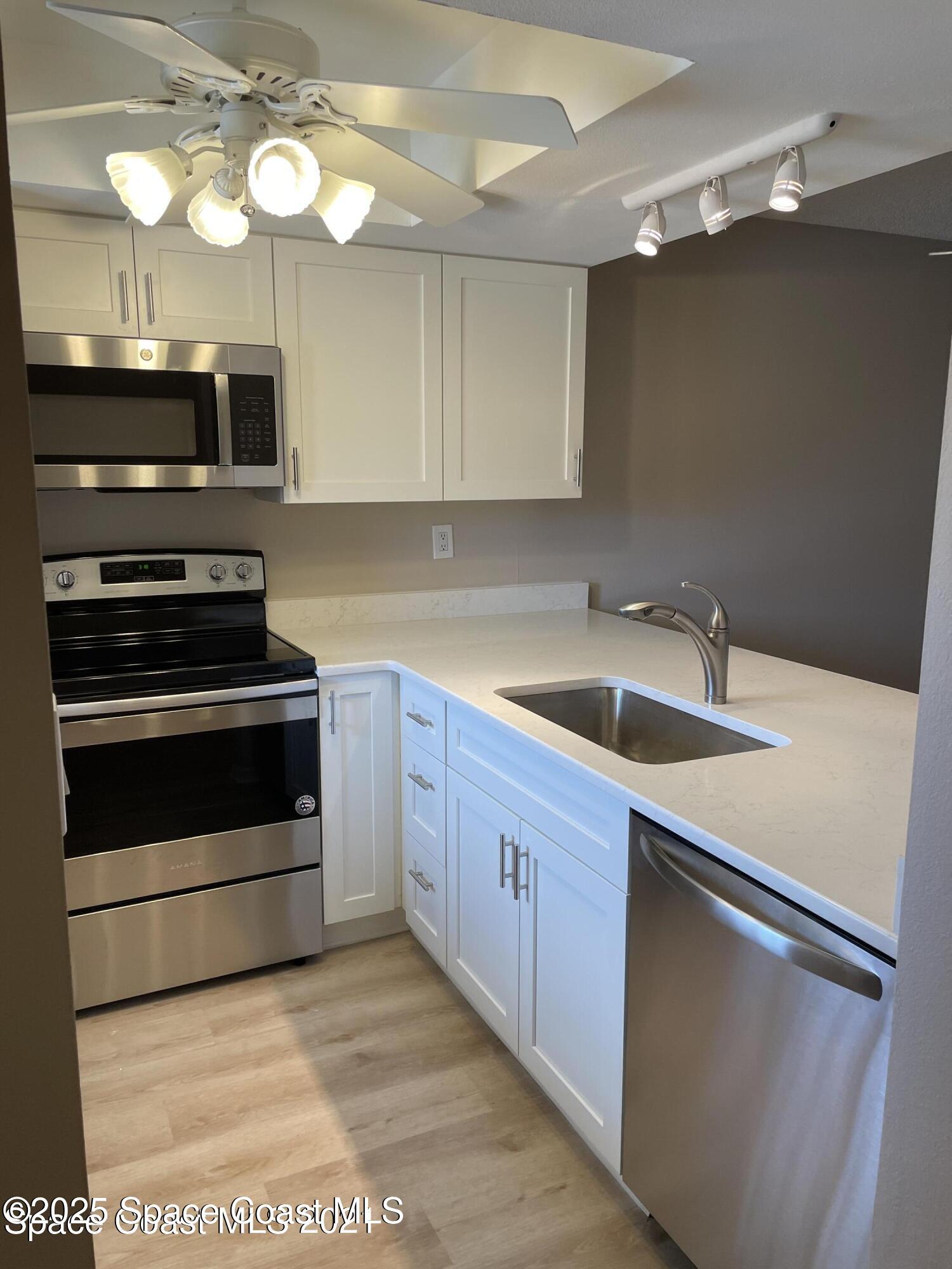 1720 Murrell Road, Unit 217 Rockledge, FL 32955 - Photo 8 of 24 a kitchen with cabinets and steel stainless steel appliances