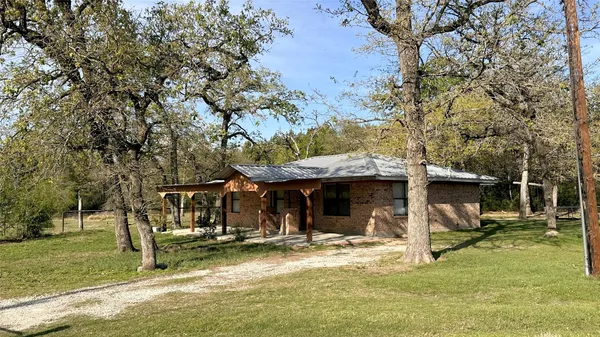 a view of a house with backyard porch and sitting area