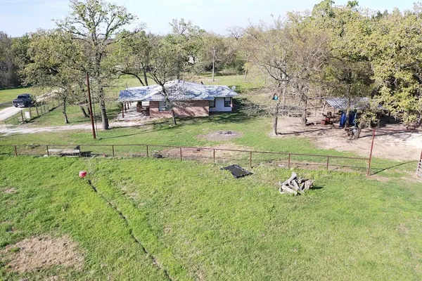 a view of a backyard with large trees