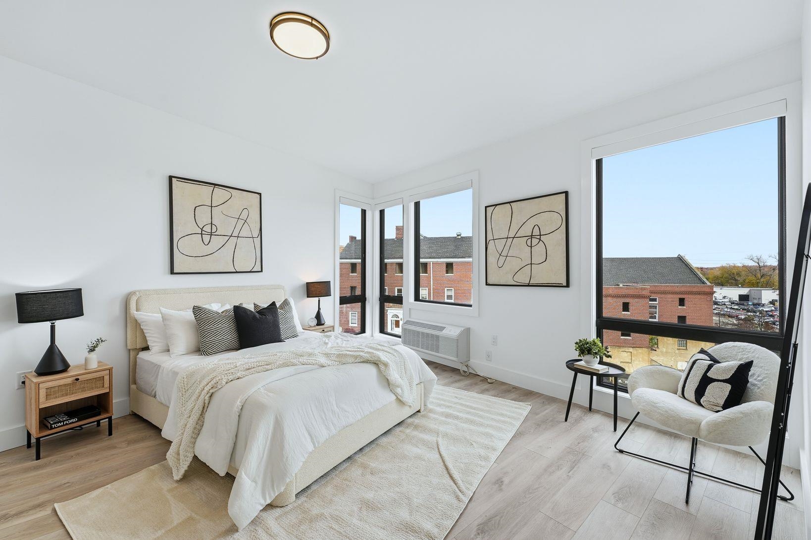 9-11 Passaic Street, Unit 203 Hackensack, NJ 07601 - Photo 6 of 13 a bedroom with a bed a couch and painting on the wall