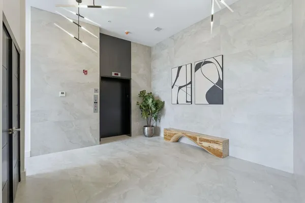 a view of a room with a sink and mirror