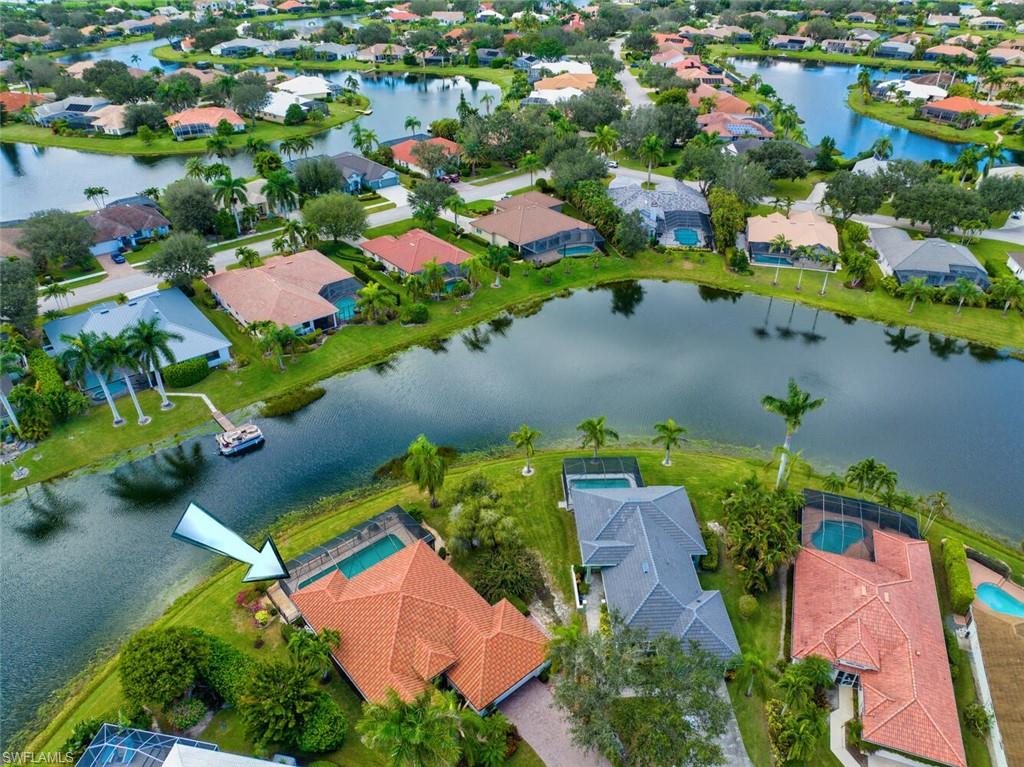 an aerial view of residential houses with outdoor space and swimming pool