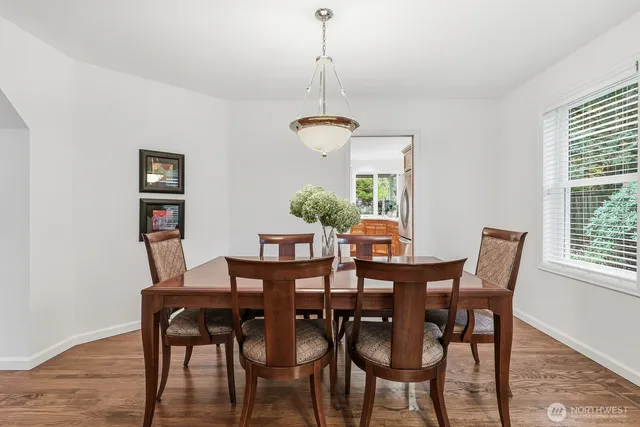 a dining room with furniture a window and a chandelier