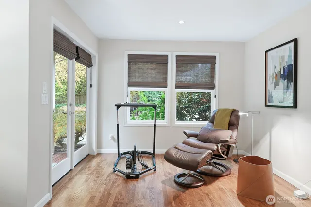 a work room with furniture and floor to ceiling windows