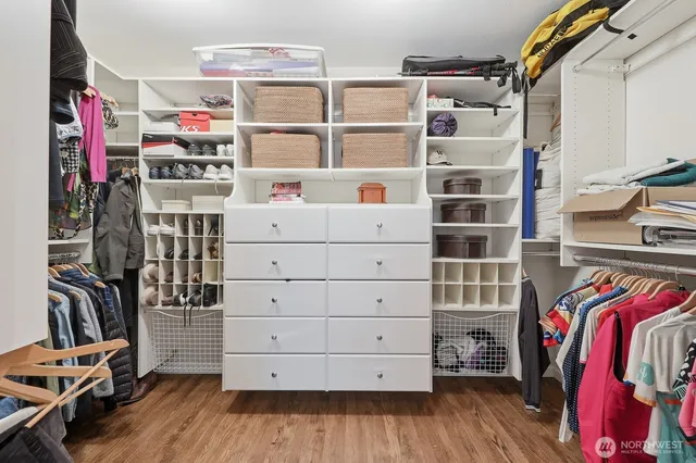 a view of walk in closet with clothes and shoes