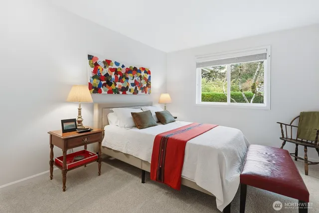 a bedroom with a bed and a table