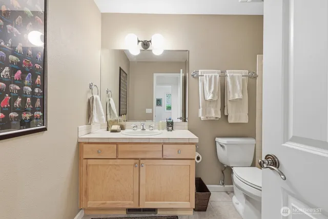 a bathroom with a toilet a sink and a mirror