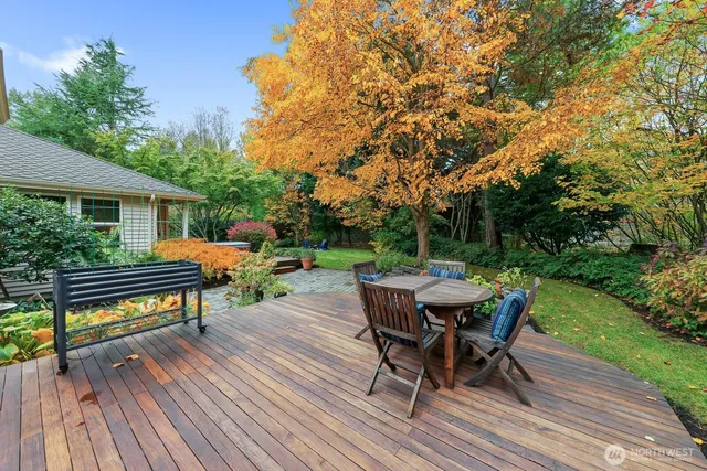 a view of a roof deck with table and chairs and wooden floor